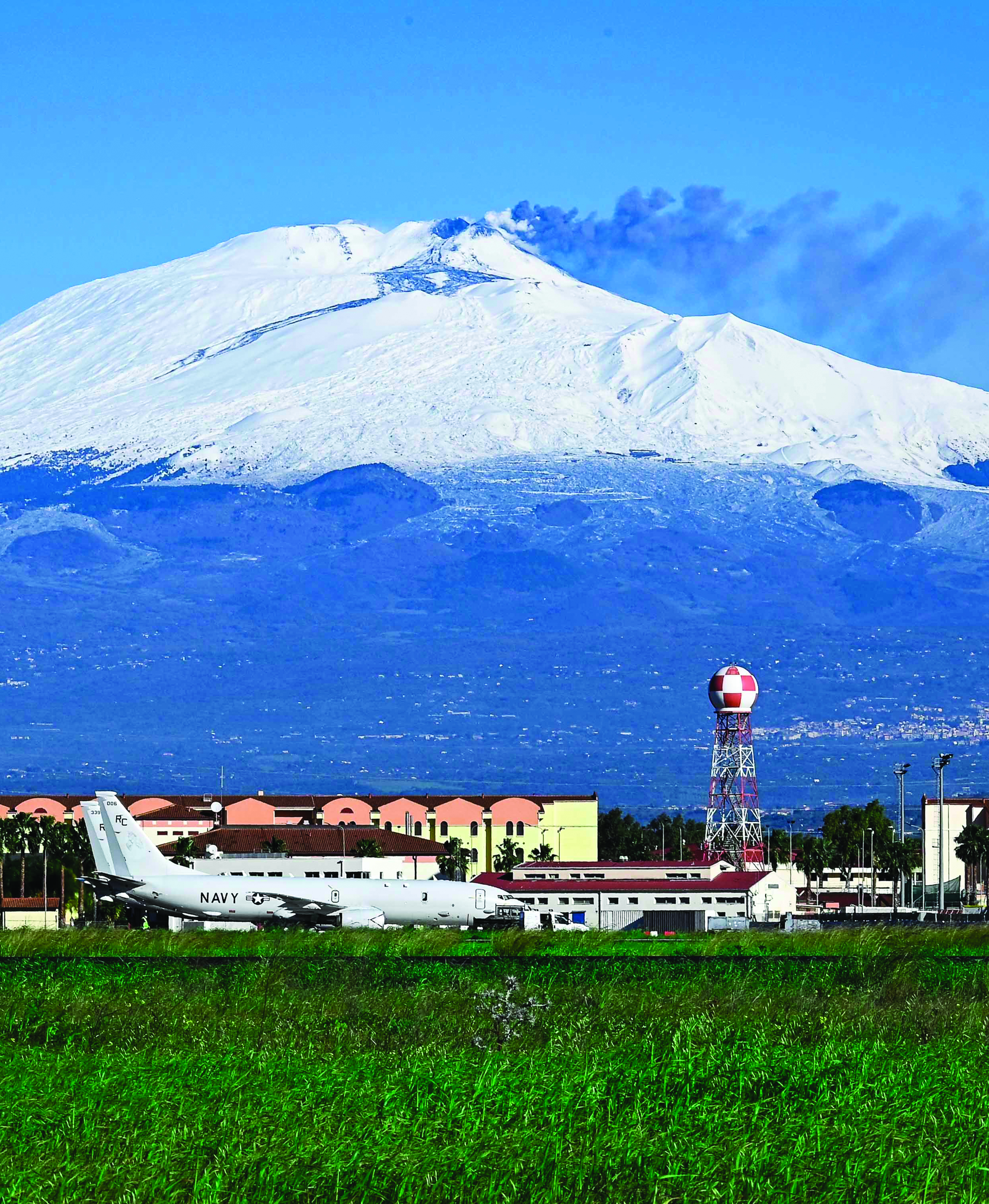 Mount Etna, an active volcano on the island
        of Sicily, is in full view behind Naval Air Station
        Sigonella. (Credit: Mass Communication Specialist
        3d Class Jacques-Laurent Jean-Gilles)